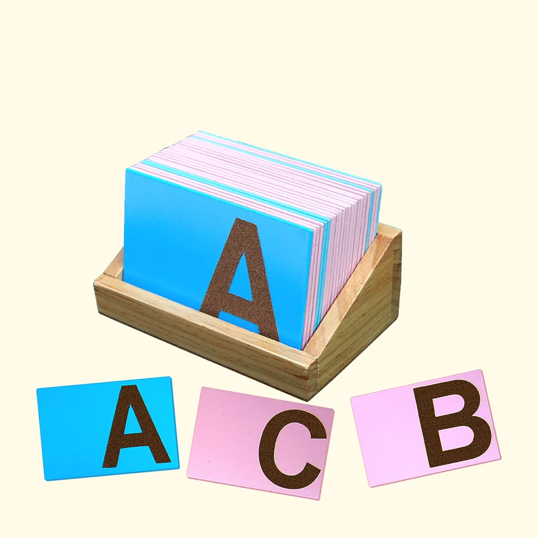 A wooden box filled with a Alphabets stack of cards.